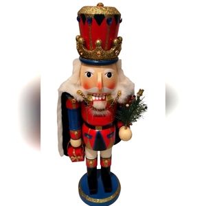 King Nutcracker With Cape Holding A Christmas Tree